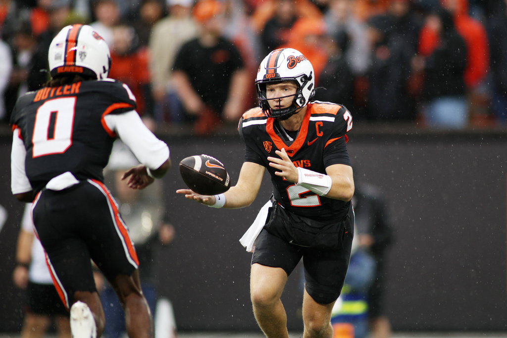 Oregon State quarterback Braden Atkinson (2) tosses the ball to wide receiver Aaron Butler (0) during the first half of an NCAA college football game against Texas Tech, Saturday, Sept. 12, 2026, in Corvallis, Ore. (AP Photo/Lydia Ely)