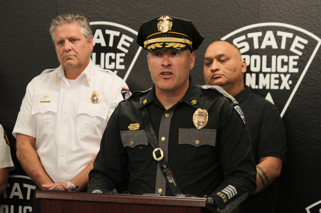 New Mexico State Police Chief Matt Broom, center, provides updates during a news conference in Albuquerque, New Mexico, on Friday, May 22, 2026 about an investigation into the deaths of three people in Torrance County and a potential fentanyl exposure for first responders who answered the call. The investigation is ongoing. (AP Photo/Susan Montoya Bryan)