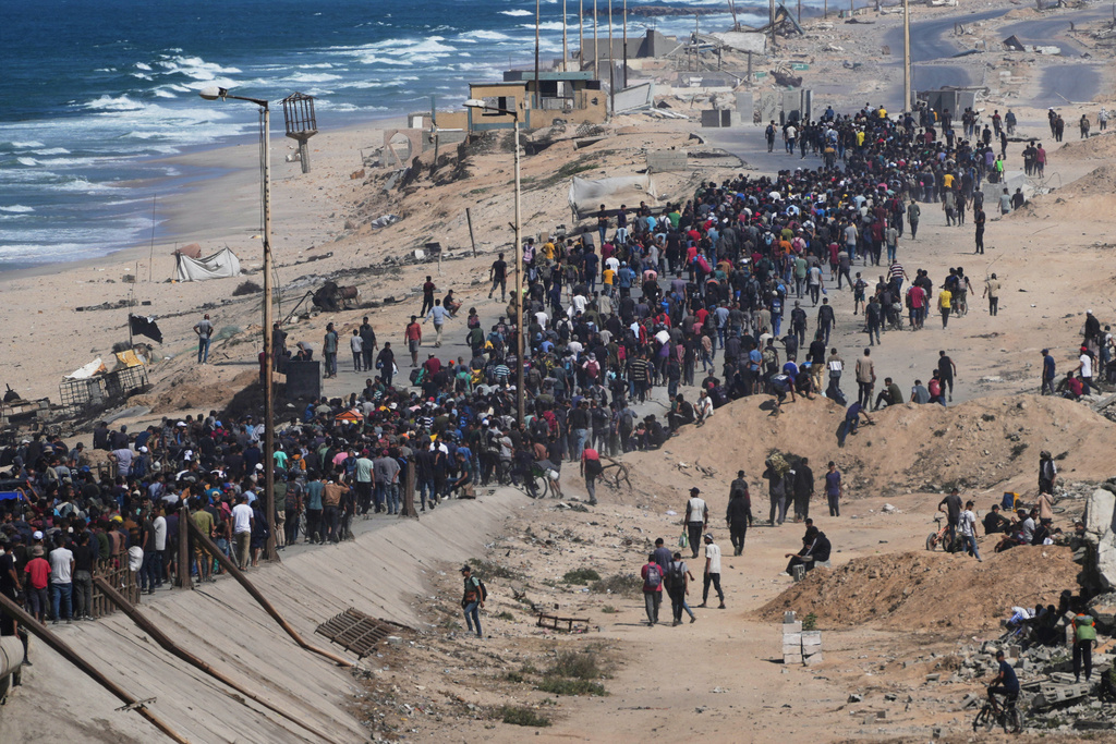 Displaced Palestinians walk along the coastal road near Wadi Gaza in the central Gaza Strip, moving toward northern Gaza, Friday, Oct. 10, 2025, after Israel and Hamas have agreed to a pause in their war and the release of the remaining hostages. (AP Photo/Abdel Kareem Hana)