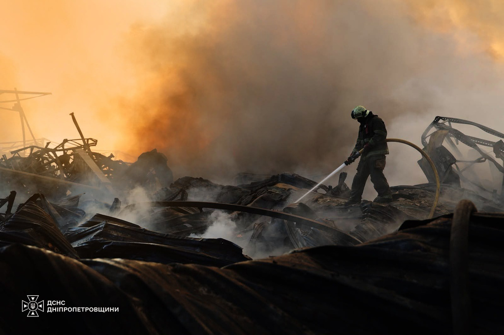 In this photo provided by the Ukrainian Emergency Service, a firefighter puts out a fire following a Russian missile attack in Dnipropetrovsk region, Ukraine, Tuesday, Aug. 4, 2026. (Ukrainian Emergency Service via AP)