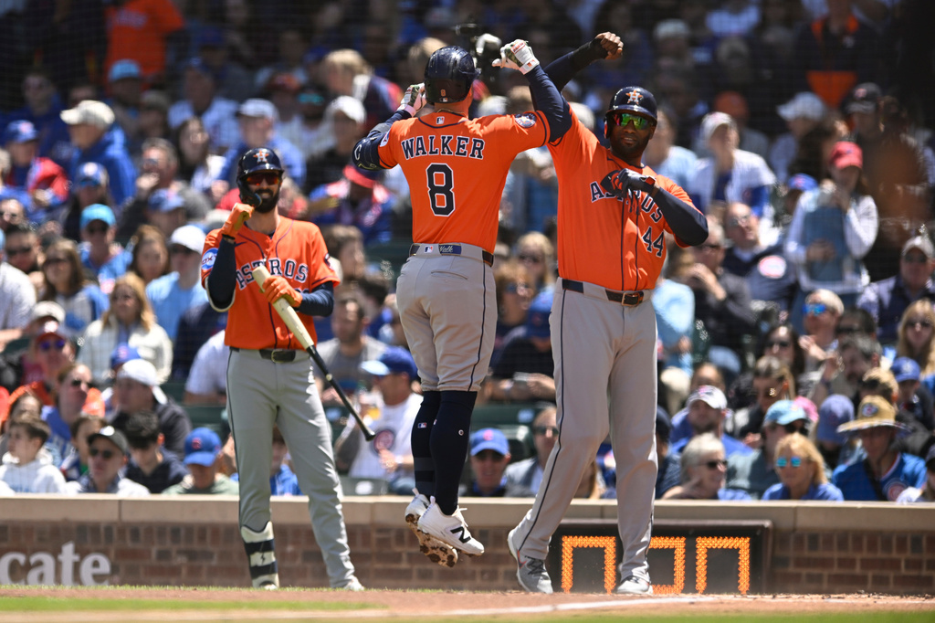 Houston Astros' Christian Walker (8) celebrates with Yordan Alvarez (44) after hitting a two-run home run during the first inning of a baseball game against the Chicago Cubs in Chicago, Saturday, May 23, 2026. (AP Photo/Paul Beaty)