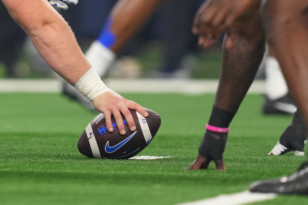 FILE - BYU prepares to snap the ball during the Big 12 Conference championship NCAA college football game between Texas Tech and BYU Saturday, Dec. 6, 2025, in Arlington, Texas. (AP Photo/Julio Cortez, File)