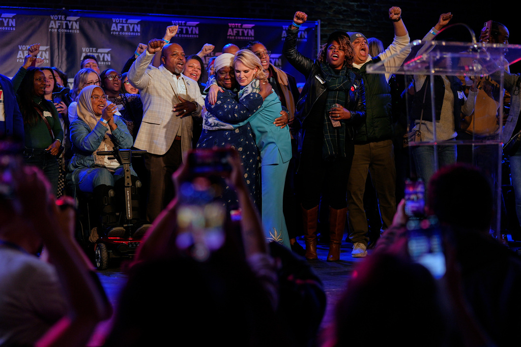 Democratic candidate State Rep. Aftyn Behn, D-Nashville, center right, hugs Zulfat Suara, center left, after losing a special election for the U.S. seventh congressional district Tuesday, Dec. 2, 2025, in Nashville, Tenn. (AP Photo/George Walker IV)
