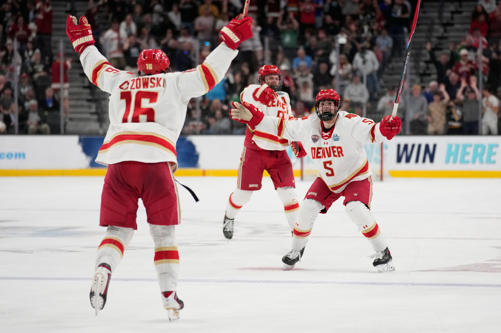 Denver players celebrate after Denver forward Kyle Chyzowski (16) scored against Wisconsin in the third period of the championship game at the NCAA Frozen Four men's college hockey tournament Saturday, April 11, 2026, in Las Vegas. (AP Photo/John Locher)