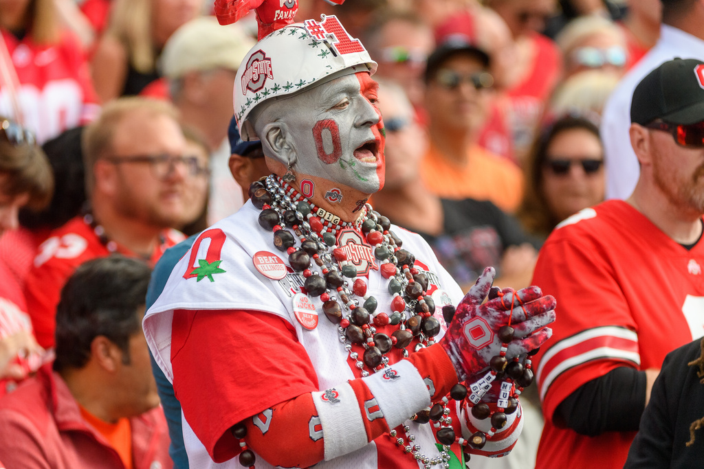 An Ohio State fan cheers during an NCAA college football game against Illinois, Saturday, Oct. 11, 2025, in Champaign, Ill. (AP Photo/Craig Pessman)