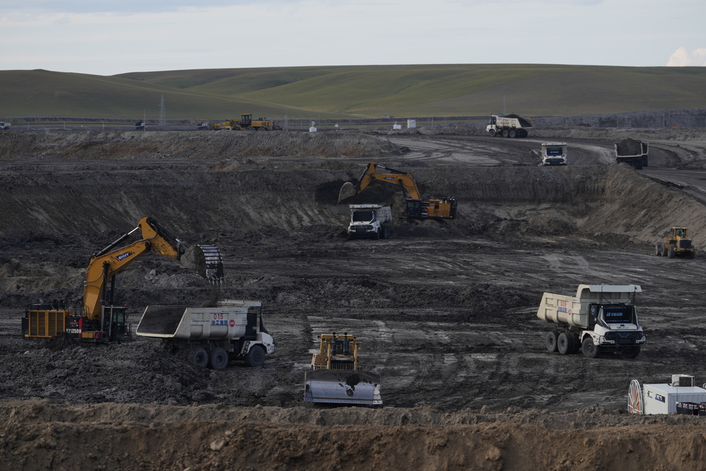 Excavators load material onto autonomous mining trucks in the Huaneng Yimin open-pit coal mine in Hulunbuir in northern China's Inner Mongolia province China, Monday, Sept. 15, 2025. (AP Photo/Ng Han Guan)
