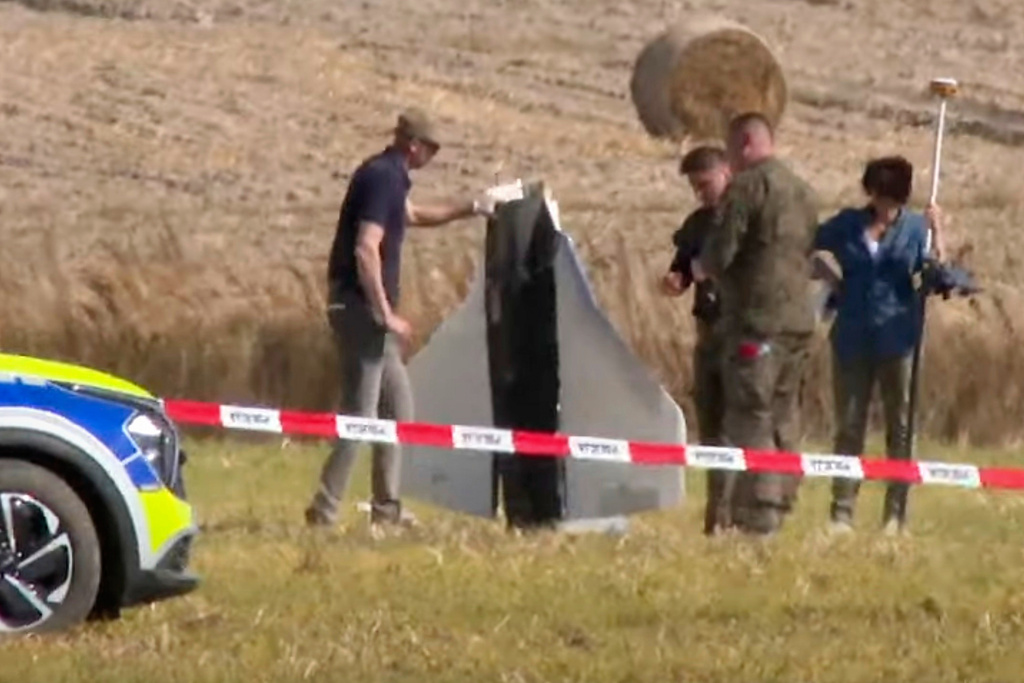 In this image made from video, Police and Military Police secure parts of a damaged object shot down by Polish authorities at a site in Wohyn, Poland, Wednesday, Sept. 10, 2025. (AP Photo/Rafal Niedzielski)