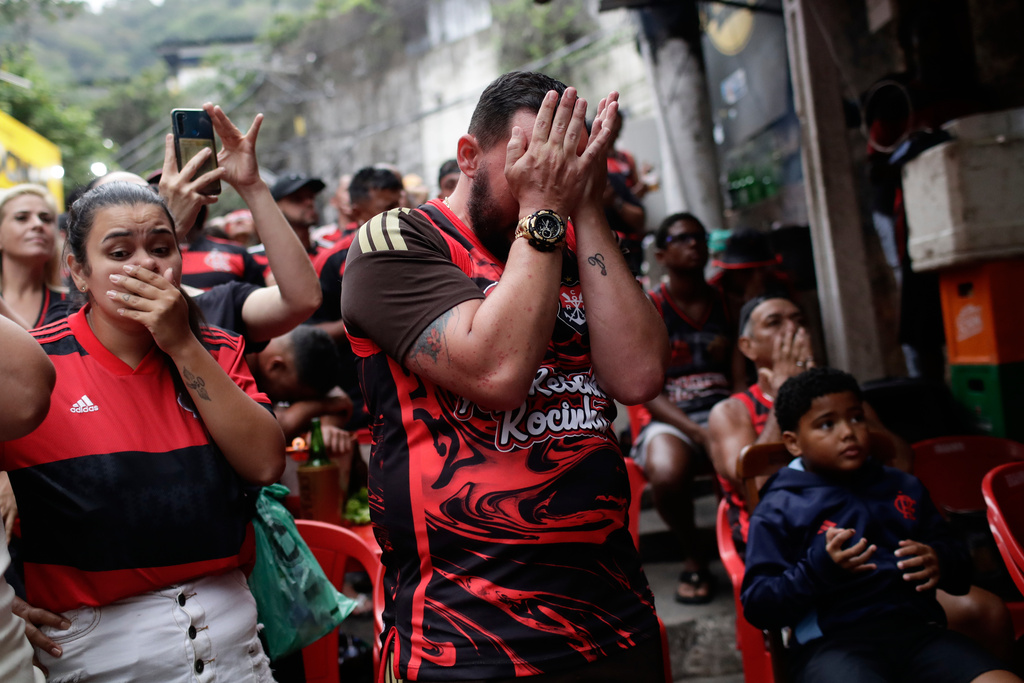 Flamengo fans react after their team lost the FIFA Intercontinental Cup final soccer match against Paris Saint-Germain in Qatar, in the Rocinha favela of Rio de Janeiro, Wednesday, Dec. 17, 2025. (AP Photo/Bruna Prado)