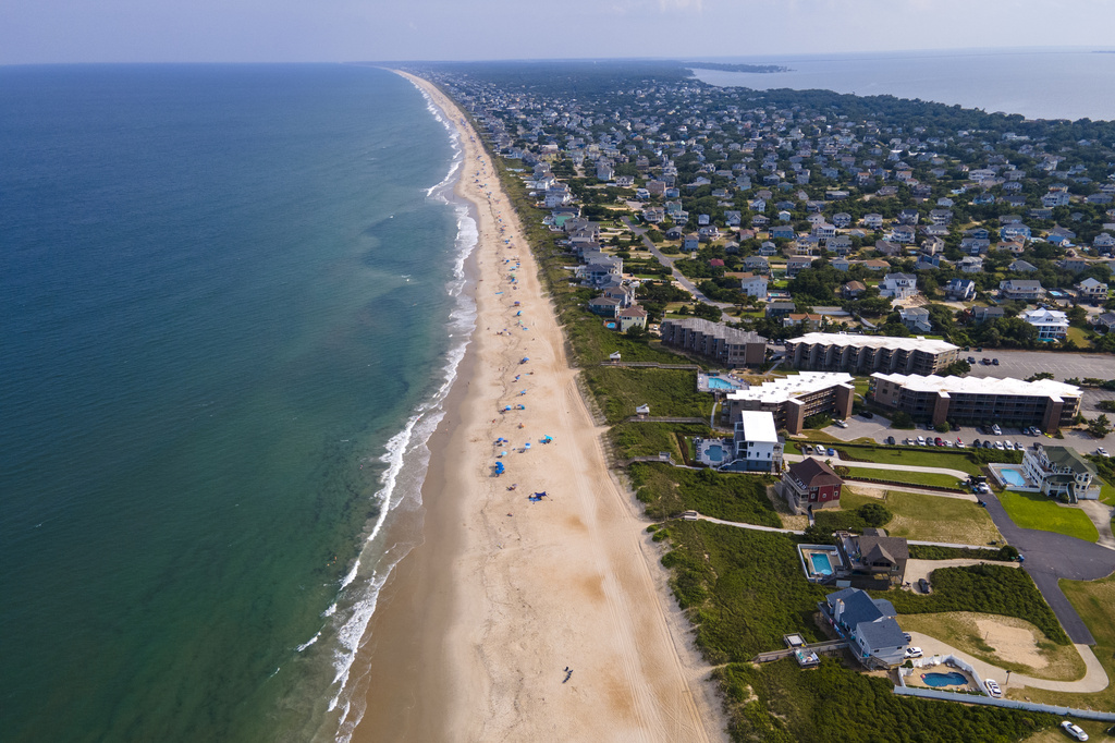FILE - The Atlantic Ocean, beach and houses are at Duck, Outer Banks, North Carolina, on Aug. 24, 2023. (AP Photo/Ted Shaffrey, file)