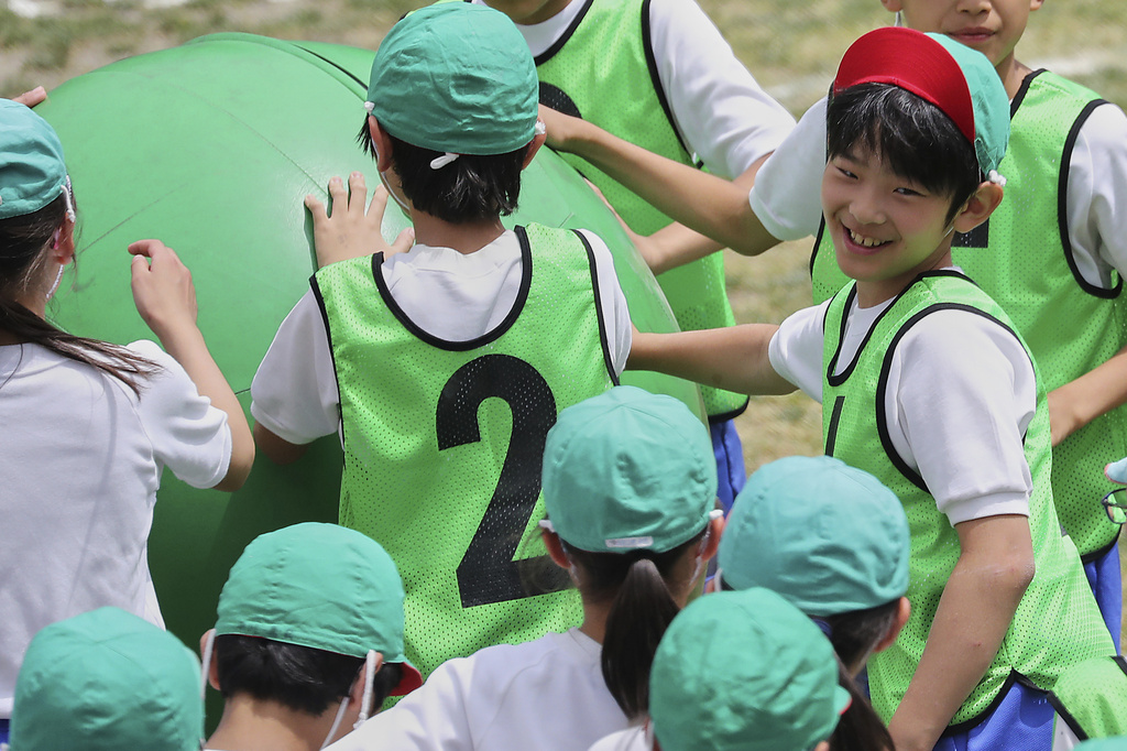 FILE - Japan's Prince Hisahito, right, participates in a sports event at a primary school affiliated with Ochanomizu University in Tokyo, May 19, 2018. (AP Photo/Eugene Hoshiko, Pool, File)