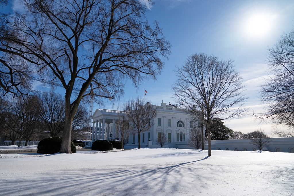 Snow covers the ground in front of the White House, Friday, Jan. 30, 2026, in Washington. (AP Photo/Allison Robbert)