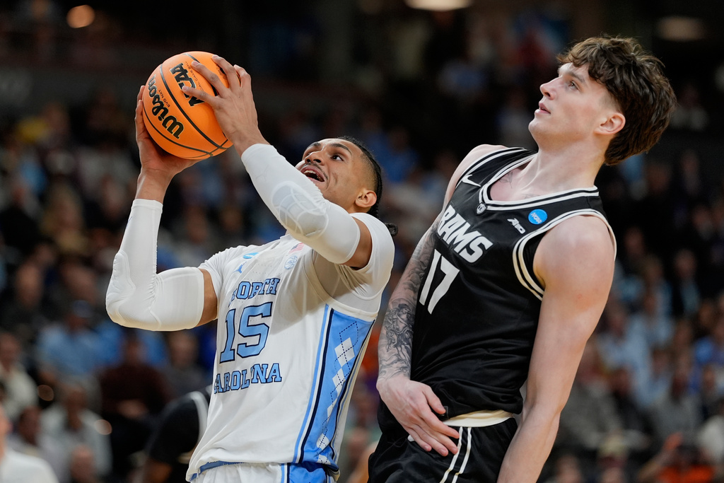 North Carolina forward Jarin Stevenson shoots over VCU forward Lazar Djokovic during the first half in the first round of the NCAA college basketball tournament, Thursday, March 19, 2026, in Greenville, S.C. (AP Photo/Chris Carlson)