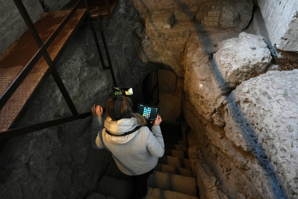 Colosseum Archeological Park guide Valentina enters the newly-restored underground House of Griffins, dated between the II and I century B.C., on the Palatine Hill next to the Colosseum, during a guided tour for the press, in Rome, Tuesday, Jan. 13, 2026. (AP Photo/Andrew Medichini)