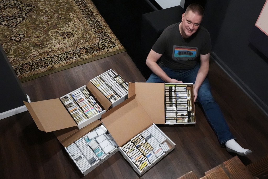 Brian Emerick poses with his recorded tapes for a photo at his home in Des Plaines, Ill., Thursday, March 19, 2026. (AP Photo/Nam Y. Huh)