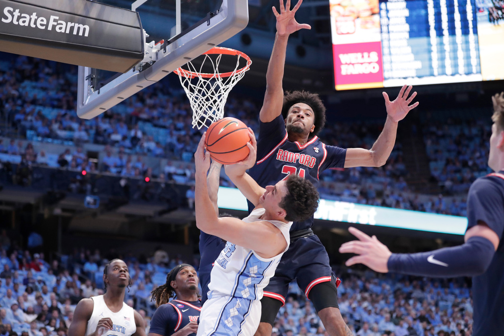 Radford forward Tyson Brown defends North Carolina guard Luka Bogavac during the first half of an NCAA college basketball game, Tuesday, Nov. 11, 2025, in Chapel Hill, N.C. (AP Photo/Chris Seward)