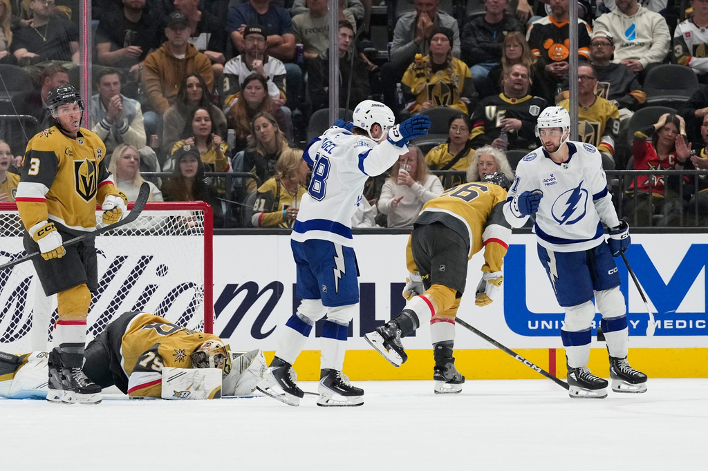 Tampa Bay Lightning center Anthony Cirelli, right, celebrates after scoring against the Vegas Golden Knights during the second period of an NHL hockey game Tuesday, Oct. 20, 2026, in Las Vegas. (AP Photo/John Locher)