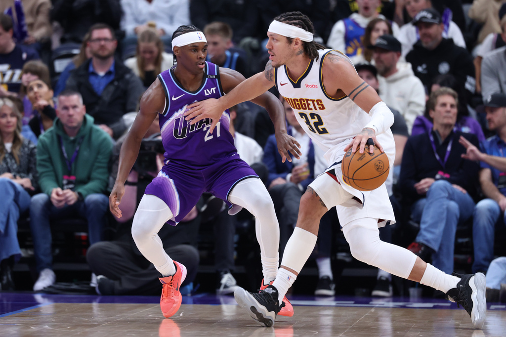 Denver Nuggets forward Aaron Gordon (32) drives with the ball against Utah Jazz guard Bez Mbeng (21) during the first half of an NBA basketball game, Wednesday, April 1, 2026, in Salt Lake City. (AP Photo/Rob Gray)