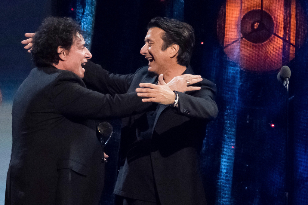 Inductees Neal Schon, left, and Steve Perry, from the band Journey, embrace at the 2017 Rock and Roll Hall of Fame induction ceremony on April 7, 2017, in New York. (Photo by Charles Sykes/Invision/AP, File)