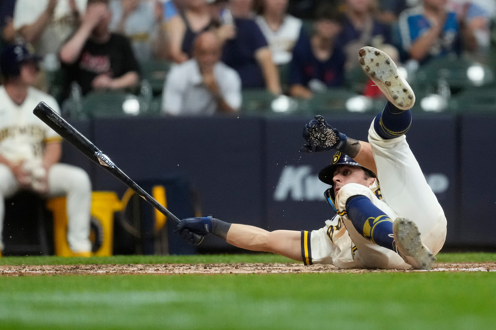 Milwaukee Brewers' Sal Frelick falls to the ground after taking a pitch to draw a walk during the sixth inning of a baseball game against the Cincinnati Reds, Monday, June 29, 2026, in Milwaukee. (AP Photo/Aaron Gash)