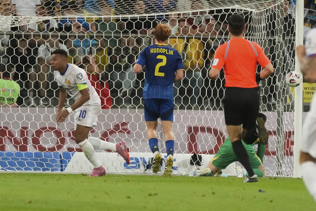 France's Kylian Mbappe, left, celebrates after scoring his side's second goal during the 2026 FIFA World Cup qualifying soccer match between Ukraine and France at Tarczynski Arena in Wroclaw, Poland, Friday, Sept. 5, 2025. (AP Photo/Czarek Sokolowski)