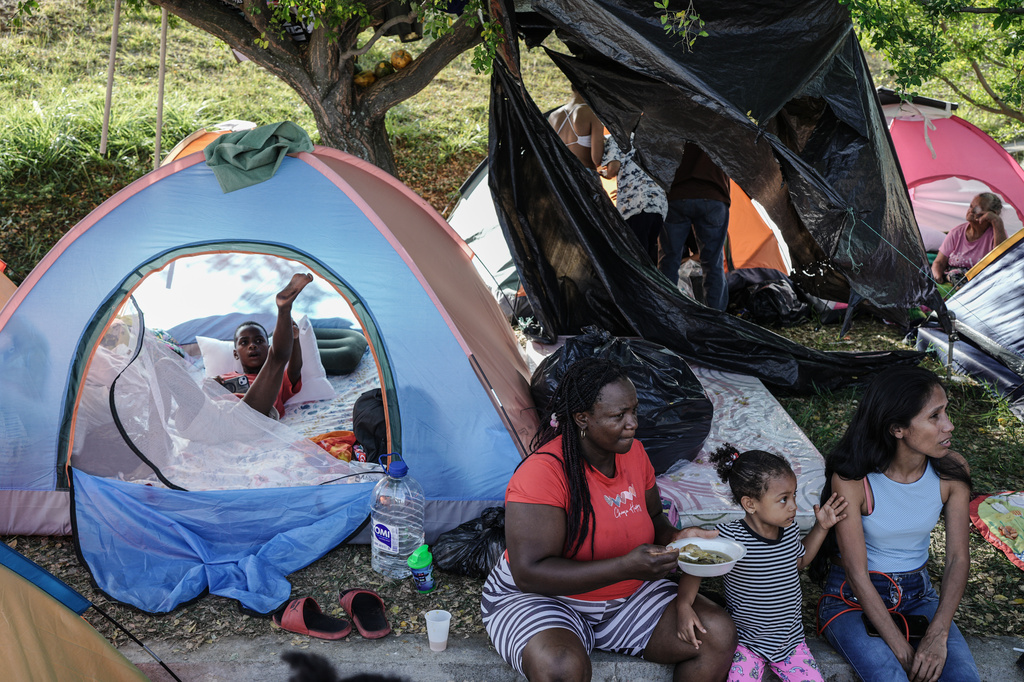 People evacuated from their earthquake-damaged homes camp in a park three days after a quake hit Cali, Colombia, Thursday, Aug. 13, 2026. (AP Photo/Ivan Valencia)