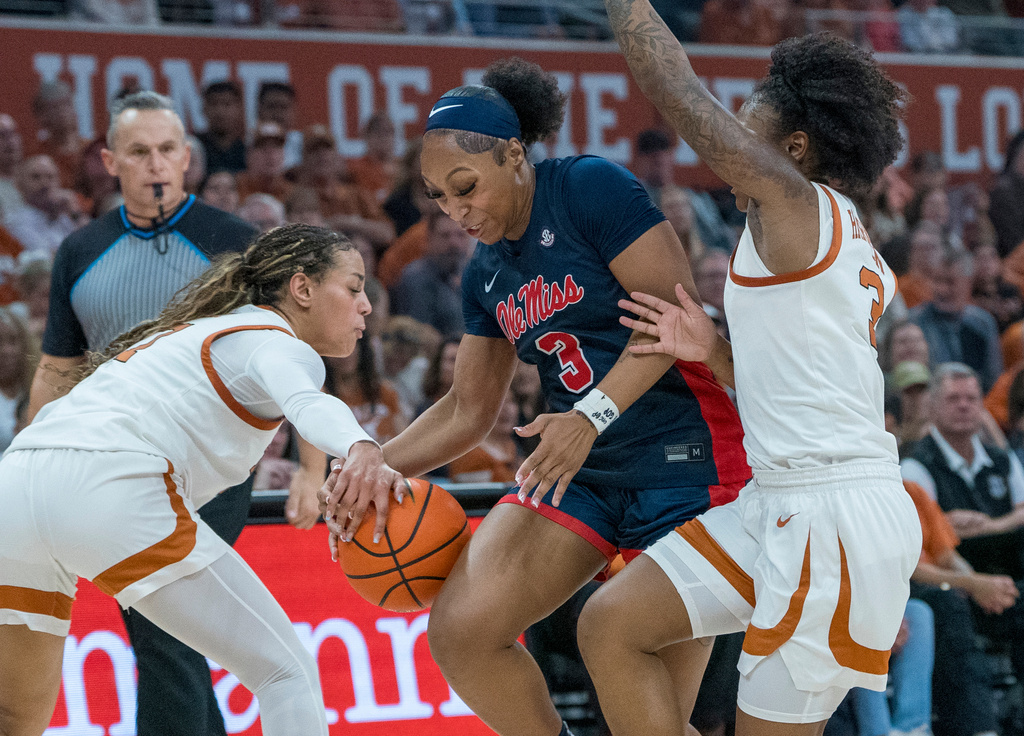 Mississippi guard Kaitlin Peterson (3) is squeezed between Texas guards Jordan Lee, left, and Rori Harmon, right, during the first half of an NCAA college basketball game in Austin, Texas, Sunday, Jan. 4, 2026. (AP Photo/Rodolfo Gonzalez)