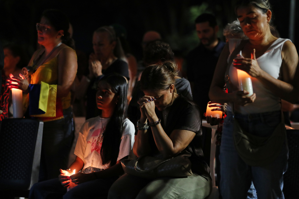 People gather at a vigil for earthquake victims in Cali, Colombia, Saturday, Aug. 15, 2026. (AP Photo/Santiago Saldarriaga)