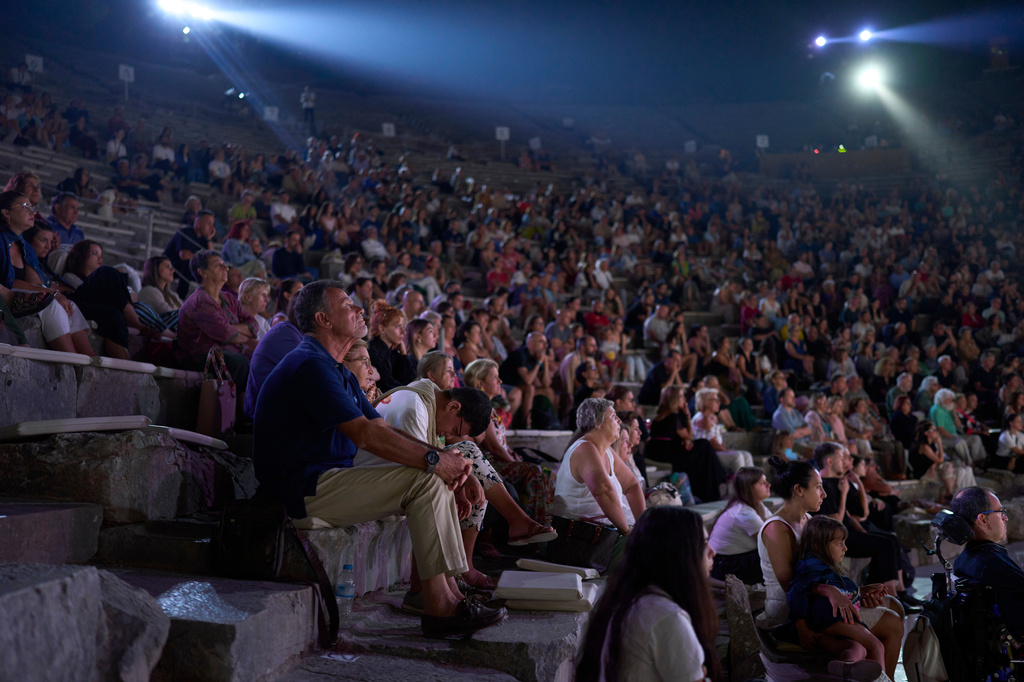 Audience members watch a performance of Euripides' tragedy The Trojan Women, staged by the National Theatre of Greece at the Ancient Theater of Epidaurus, Greece, on Sunday, Aug. 2, 2026. (AP Photo/Petros Giannakouris)