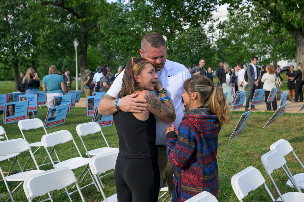Brittney Bird, from left, is comforted by her husband Luke Bird and daughter Aurora Bird as they remember her son Bradyn Bohn, 15, during a Social Media Victims Remembrance Day memorial on Capitol Hill, Tuesday, June 23, 2026, in Washington. (AP Photo/Rod Lamkey, Jr.)