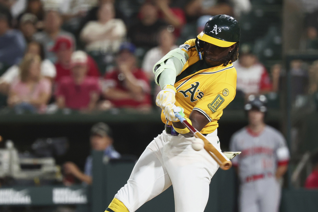 Athletics' Lawrence Butler hits a single during the eighth inning of a baseball game against the Cincinnati Reds Friday, Sept. 12, 2025, in West Sacramento, Calif. (AP Photo/Sara Nevis)