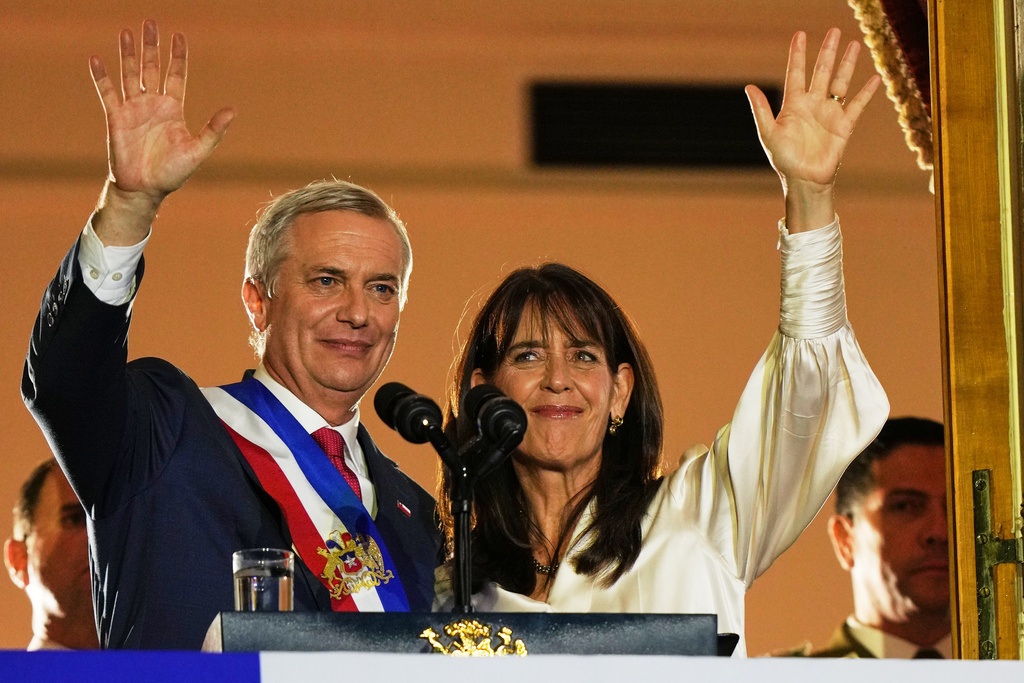 Chile's President Jose Antonio Kast and his wife Maria Pia Adriasola wave to supporters from the balcony of La Moneda presidential palace after his inauguration in Santiago, Chile, Wednesday, March 11, 2026. (AP Photo/Esteban Felix)