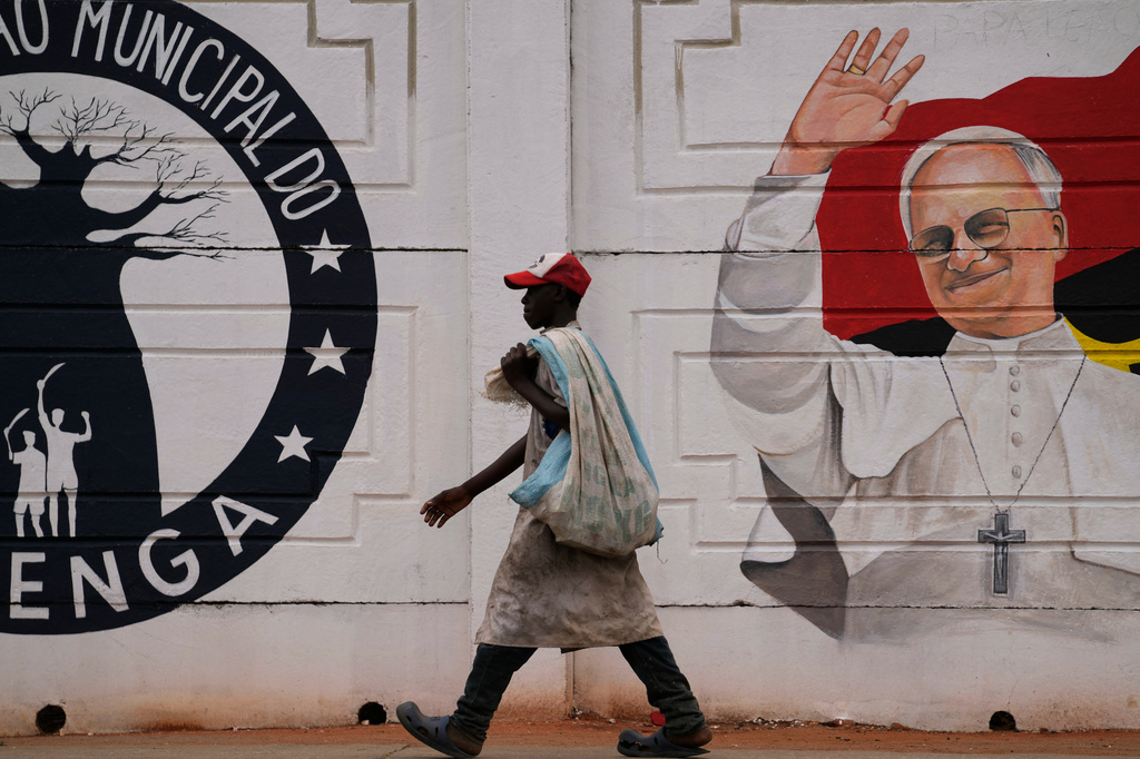A man walks past a mural of Pope Leo XIV in Luanda, South Africa, Thursday, April 16, 2026. (AP Photo/Themba Hadebe)
