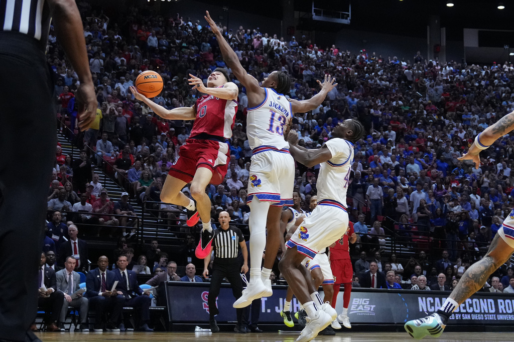 St. John's guard Dylan Darling (0) shoots with less than a second left against Kansas during the second half of a game in the second round of the NCAA college basketball tournament Sunday, March 22, 2026, in San Diego. (AP Photo/Marcio Jose Sanchez)