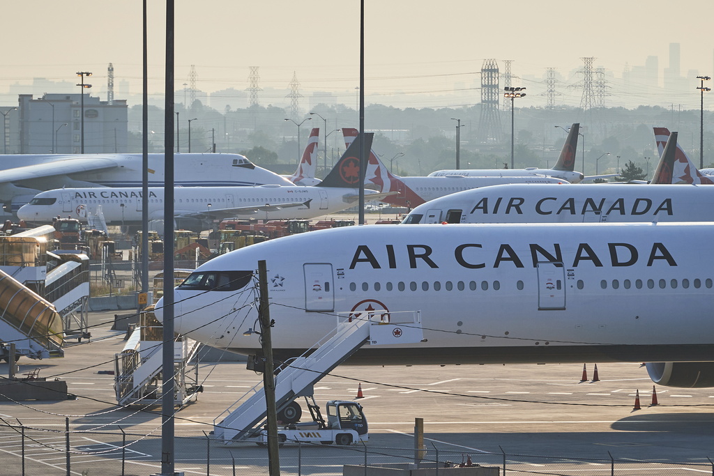 Air Canada planes sit on the runway at Pearson International Airport as flight attendants go on strike in Toronto on Saturday, Aug. 16, 2025. (Sammy Kogan/The Canadian Press via AP)