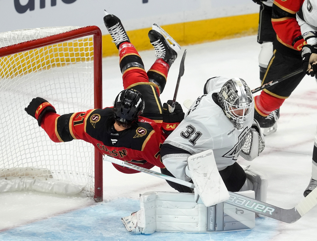 Ottawa Senators center Nick Cousins (21) falls over Los Angeles Kings goaltender Anton Forsberg (31) during the first period of an NHL hockey game in Ottawa, Ontario, Saturday, Nov. 15, 2025. (Adrian Wyld/The Canadian Press via AP)