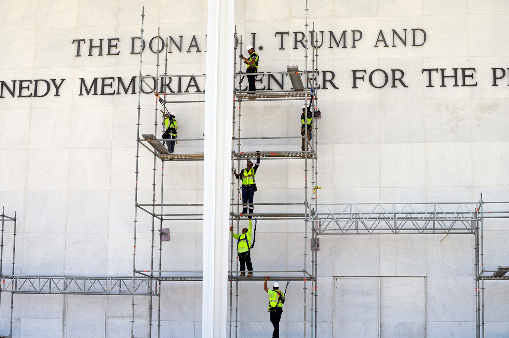 Workers erect scaffolding in front of the John F. Kennedy Center for the Performing Arts sign in Washington, Friday, June 12, 2026. (AP Photo/Cliff Owen)