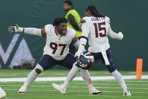 Denver Broncos defensive tackle Malcolm Roach (97) and Denver Broncos linebacker Nik Bonitto (15) celebrate after the NFL football game between the Denver Broncos and the New York Jets, Sunday, Oct. 12, 2025, in London. (AP Photo/Kin Cheung) Denver Broncos defensive tackle Malcolm Roach (97) and Denver Broncos linebacker Nik Bonitto (15) celebrate after the NFL football game between the Denver Broncos and the New York Jets, Sunday, Oct. 12, 2025, in London. (AP Photo/Kin Cheung)