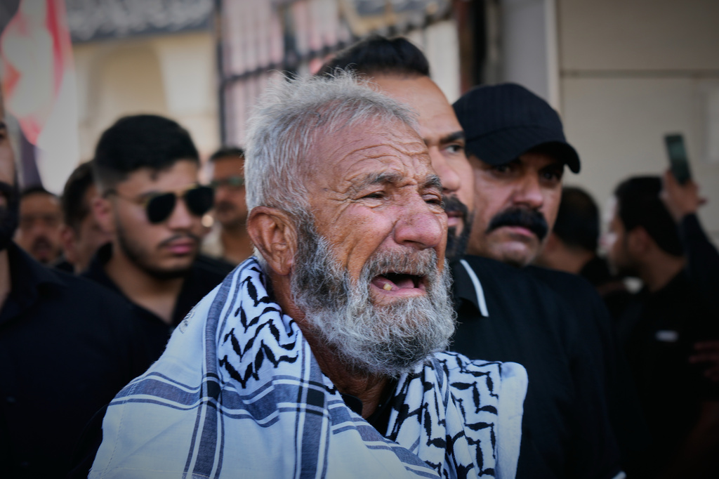 A mourner weeps during a group funeral for Iranian advisers and Popular Mobilization Forces fighters killed in airstrikes on bases belonging to Iraq's Popular Mobilization Forces, a coalition of predominantly Shiite militias that includes Iran-backed groups, in Mosul, Iraq, Wednesday, July 29, 2026. (AP Photo/Hadi Mizban)