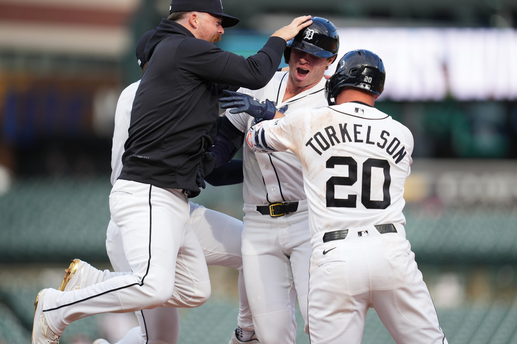 Detroit Tigers' Colt Keith, center, celebrates his one-run single with Jake Rogers, left, andSpencer Torkelson (20) against the Kansas City Royals during the ninth inning of a baseball game Thursday, April 16, 2026, in Detroit. (AP Photo/Paul Sancya)