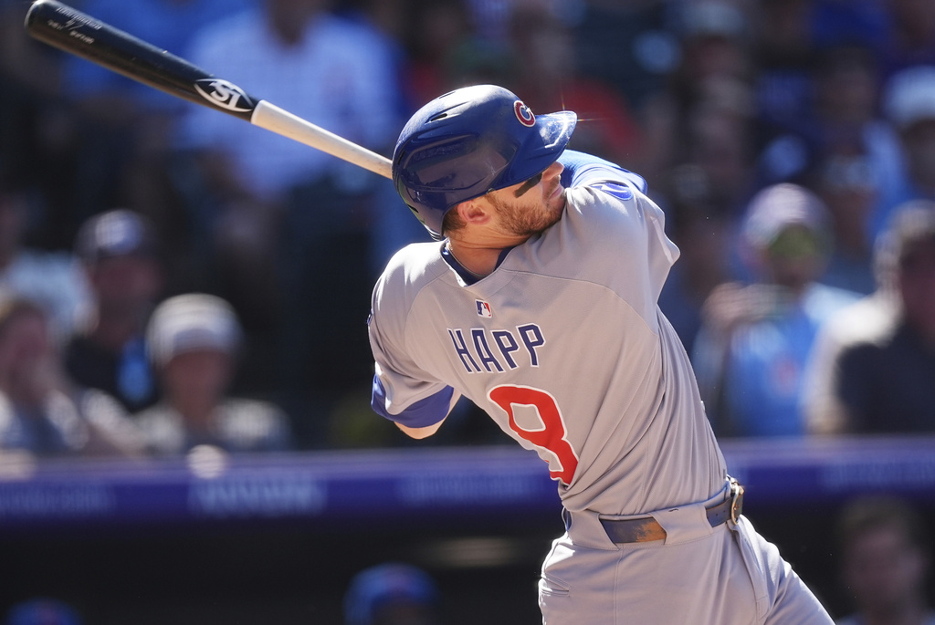 Chicago Cubs' Ian Happ follows through with his swing after connecting for a three-run home run off Colorado Rockies relief pitcher Luis Peralta in the eighth inning of a baseball game Sunday, Aug. 31, 2025, in Denver. (AP Photo/David Zalubowski)