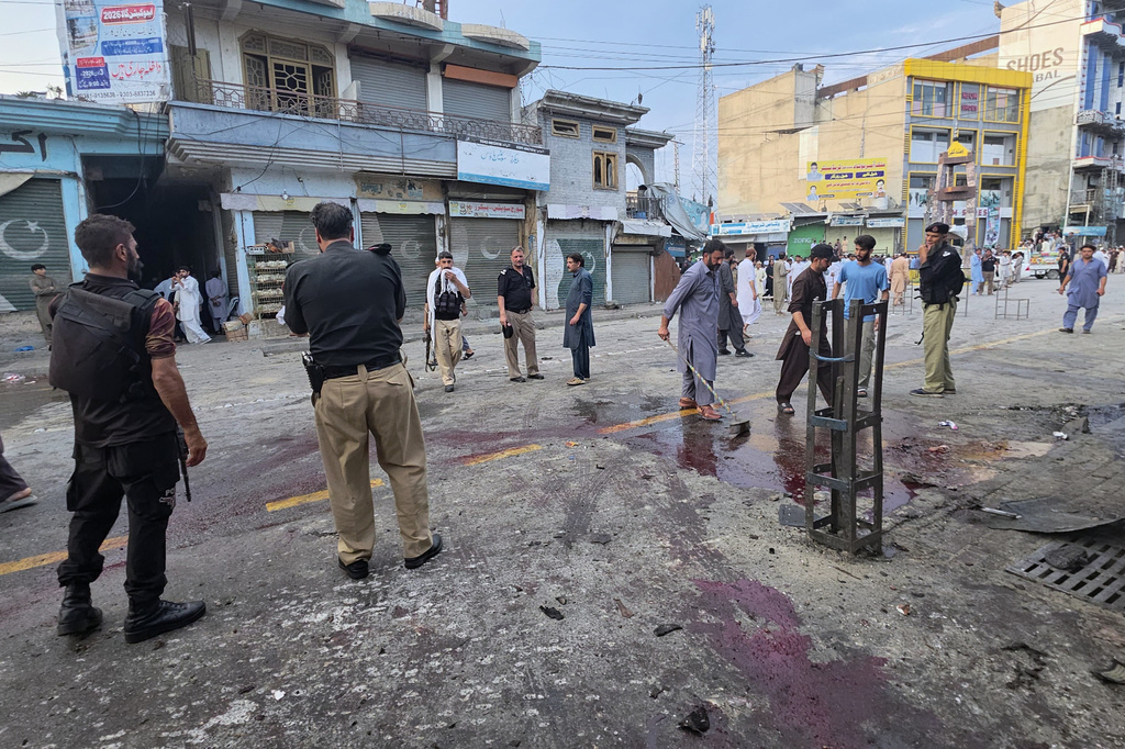 Police officers examine the site following a suicide bombing, in Kabal, a town in the Swat Valley in Pakistan's Khyber Pakhtunkhwa province, Sunday, Aug. 2, 2026. (AP Photo/Sherin Zada)