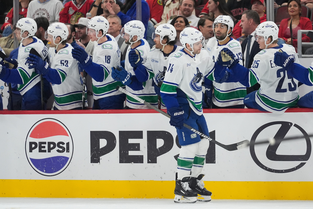 Vancouver Canucks left wing Jake Debrusk (74) celebrates his goal against the Chicago Blackhawks during the second period of an NHL hockey game Friday, Oct. 17, 2025, in Chicago. (AP Photo/Erin Hooley)