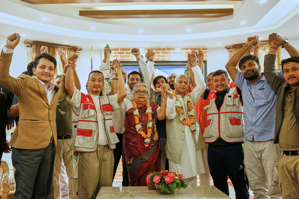 "Gen Z" leaders and others raise their hands with former Supreme Court Chief Justice Sushila Karki, center, after she was sworn in as interim prime minister at the presidential residence in Kathmandu, Nepal, Friday, Sept. 12, 2025. (AP Photo/Sujan Gurung)