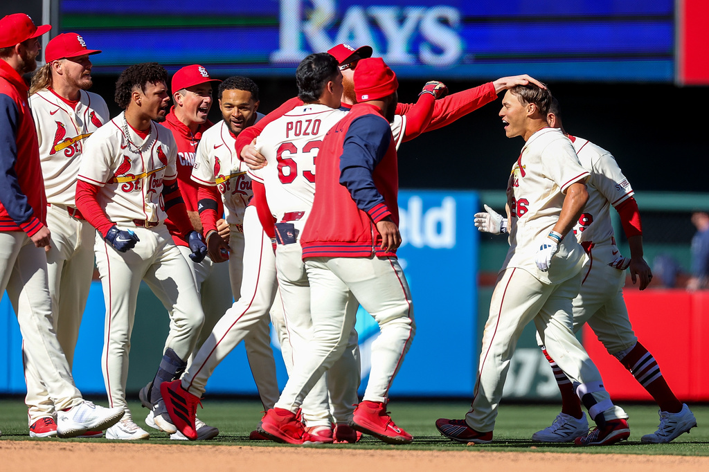 St. Louis Cardinals' JJ Wetherholt, right, is congratulated by teammates after driving in the game-winning runs in the tenth inning of a baseball game against the Tampa Bay Rays, Saturday, March 28, 2026, in St. Louis. (AP Photo/Scott Kane)