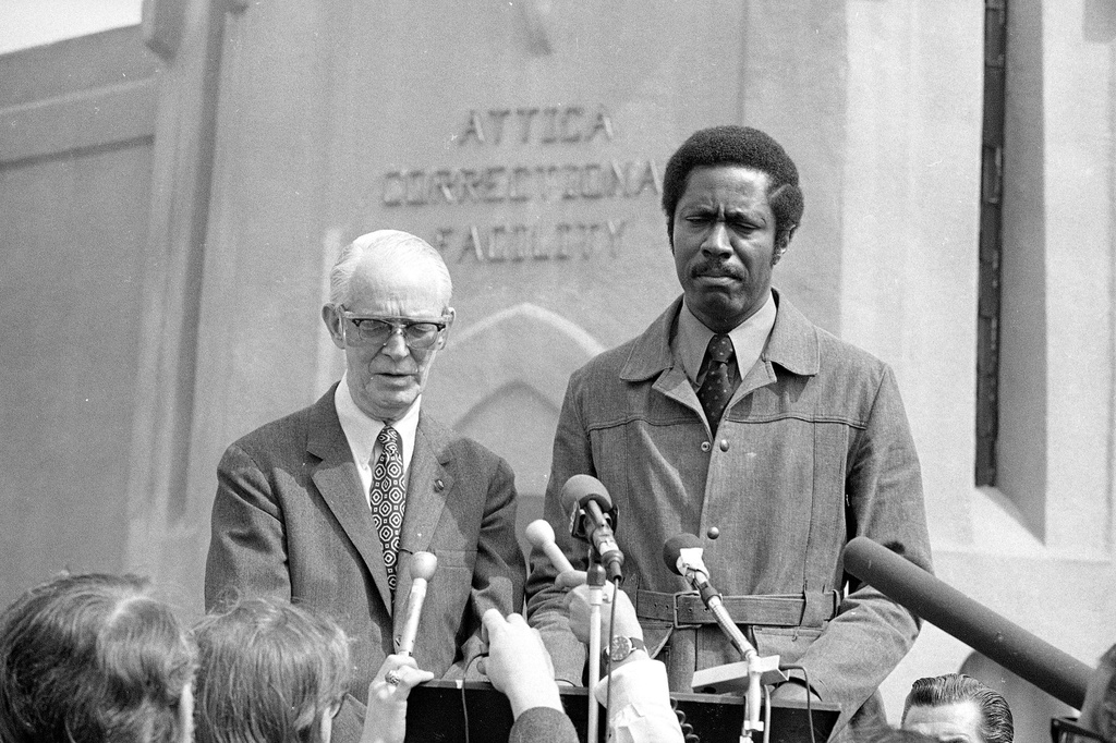 FILE - Austin McCormack, left, co-chairman of the Goldman Citizens Committee appointed to investigate the Attica prison riot, stands next to Dr. Clarence B. Jones, editor and publisher of the Amsterdam News as they hold a news conference, Sept. 17, 1971, shortly after their arrival at the upstate New York prison. (AP Photo/Bob Schutz)