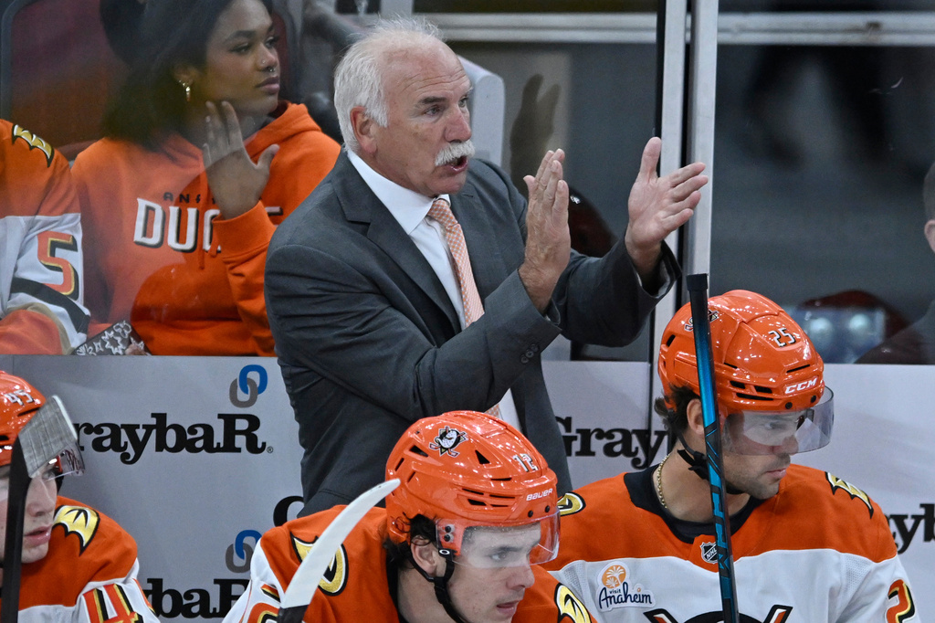 Anaheim Ducks head coach Joel Quenneville, center top, yells to his players during the second period of an NHL hockey game against the Chicago Blackhawks, Sunday, Oct. 19, 2025, in Chicago. (AP Photo/Paul Beaty)
