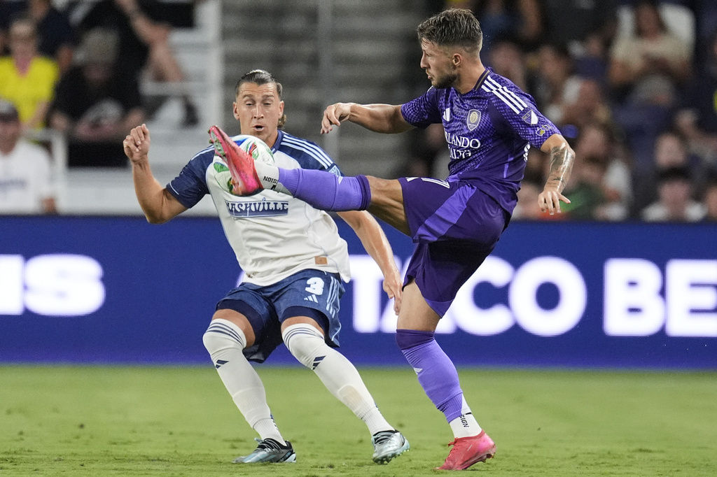 Orlando City forward Marco Pašalić, right, kicks the ball past Nashville SC defender Tate Schmitt (3) during the second half of an MLS soccer match Saturday, Aug. 23, 2025, in Nashville, Tenn. (AP Photo/George Walker IV)
