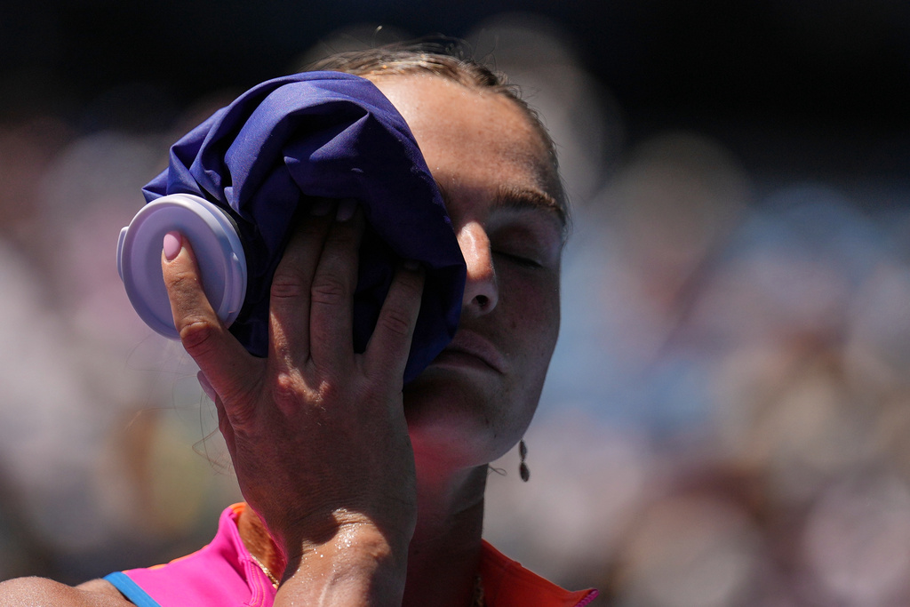 Aryna Sabalenka of Belarus places an ice pack to her face during their quarterfinal match against Iva Jovic of the U.S. at the Australian Open tennis championship in Melbourne, Australia, Tuesday, Jan. 27, 2026. (AP Photo/Dita Alangkara)