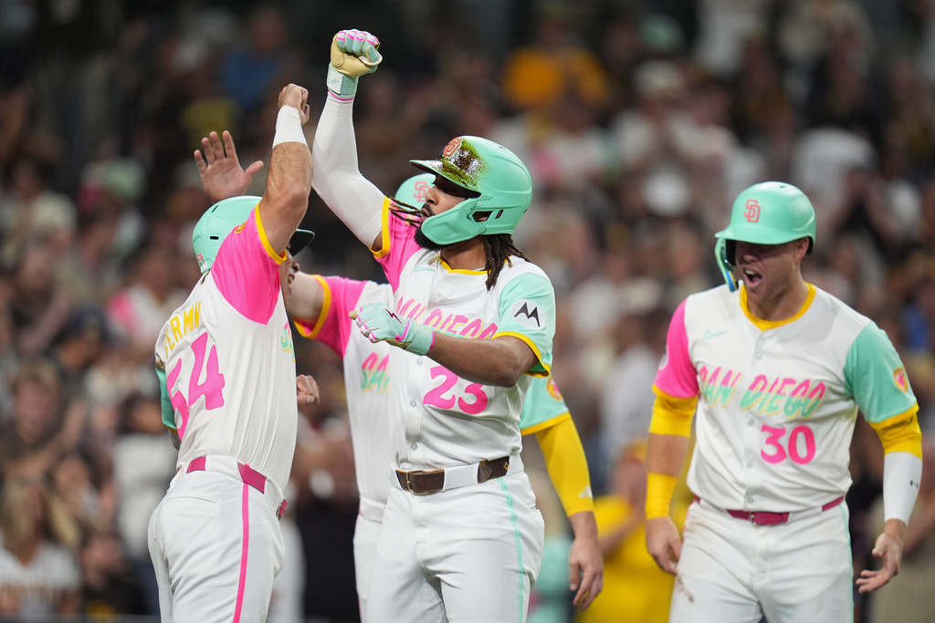 San Diego Padres' Fernando Tatis Jr. celebrates with teammates after hitting a grand slam during the fourth inning of a baseball game against the Arizona Diamondbacks Friday, Sept. 26, 2025, in San Diego. (AP Photo/Gregory Bull)
