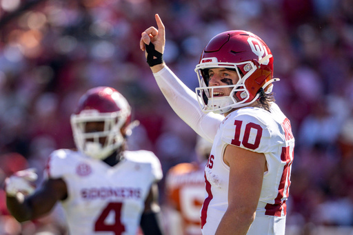 Oklahoma quarterback John Mateer signals to the sideline during the first half of an NCAA college football game against Texas, Saturday, Oct. 11, 2025, in Dallas. (AP Photo/Jeffrey McWhorter) Oklahoma quarterback John Mateer signals to the sideline during the first half of an NCAA college football game against Texas, Saturday, Oct. 11, 2025, in Dallas. (AP Photo/Jeffrey McWhorter)